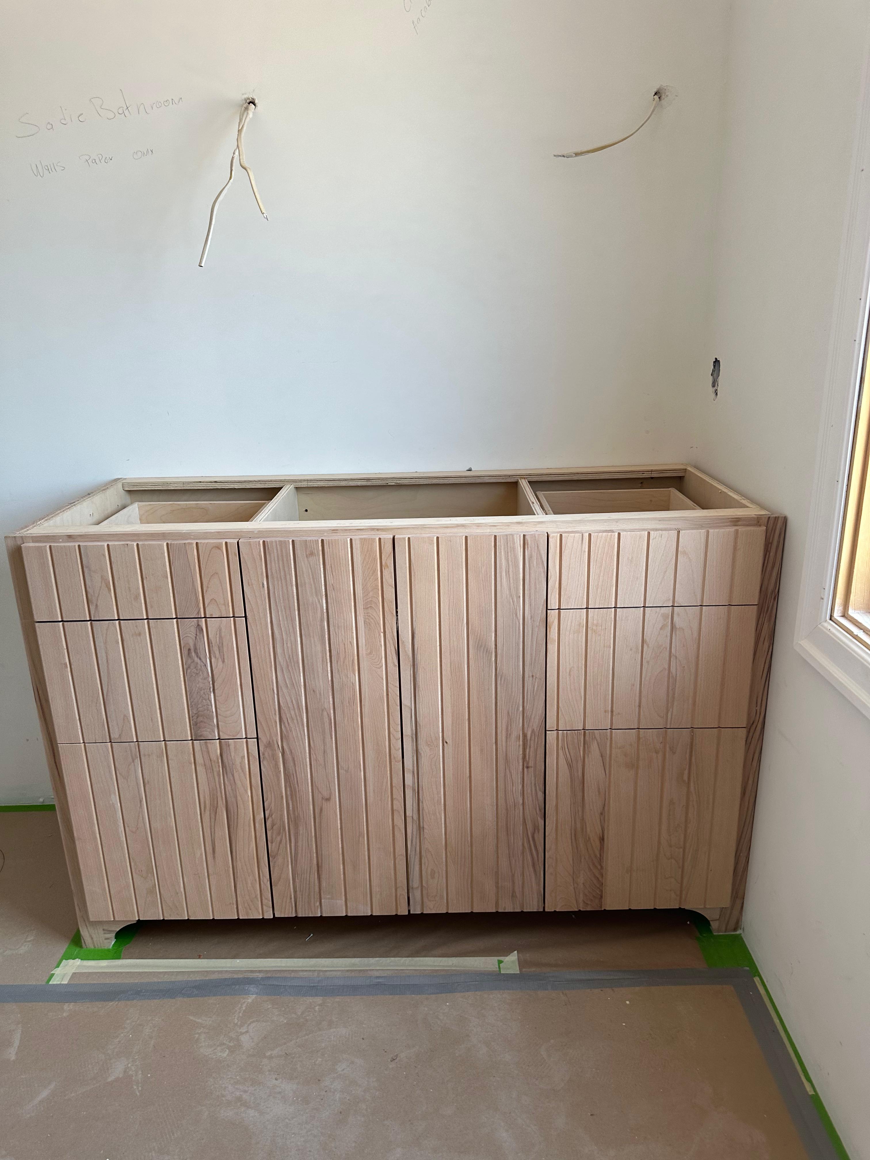 Grey built-in desk with glass-front bookcases
